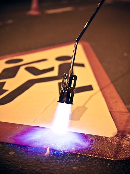 PREMARK danger sign application with a blow torch