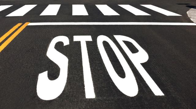 OPTATRAC STOP letters and pedestrian crossing