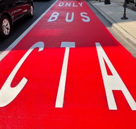 White letters on road with OPTATRAC on PlastiRoute MMA resin