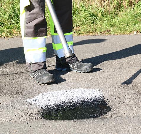 Application of ChipFill with a blower to fill potholes